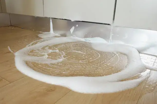 Soapy water spill on a wooden floor, creating foam and bubbles. -best floor cleaner