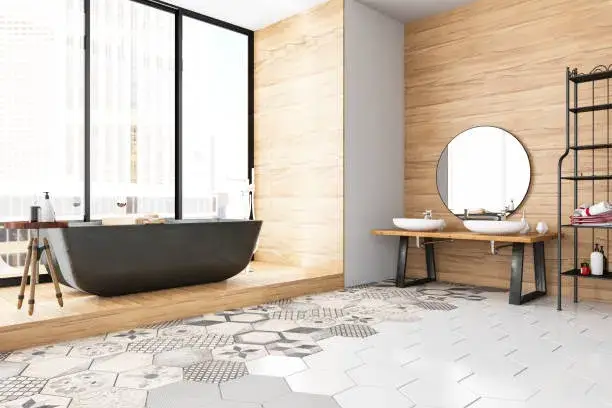 Contemporary bathroom with hexagonal patterned floor tiles, a raised freestanding bathtub, and wooden wall accents. -bathroom floor tile